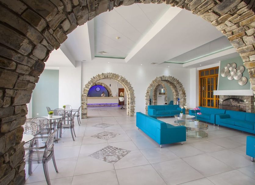 Cyprotel Florida, Ayia Napa: stone-arched hotel lounge with turquoise sofas and tiled floor