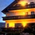 Hotel Schauinsland in Bad Peterstal-Griesbach with warmly lit balconies at dusk