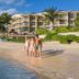 Hotel Marina El Cid Spa in Puerto Morelos: beachside resort with palm trees and oceanfront pool