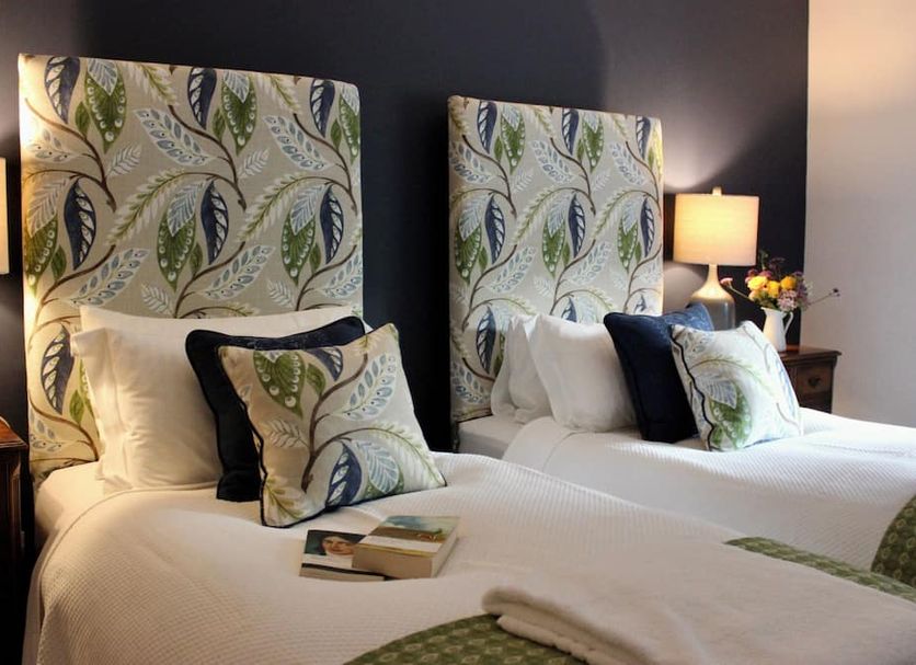 Pardlestone Farm B&B in Watchet, twin beds with leaf-print headboards and bedside lamps
