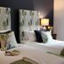Pardlestone Farm B&B in Watchet, twin beds with leaf-print headboards and bedside lamps