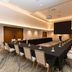 Hilton Garden Inn Sioux Falls Downtown meeting room with U-shaped conference table and projector screen