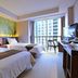 Midtown Hotel Surabaya guest room with two twin beds and city-view window