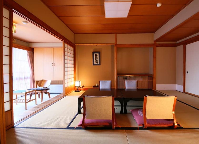 Yorozuya in Yamanouchi tatami room with low table, cushions, and adjoining sitting area