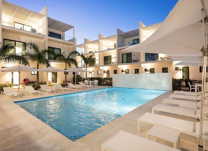 Seascape Hotel in Providenciales courtyard pool with lounge chairs and palm trees at dusk