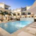 Seascape Hotel in Providenciales courtyard pool with lounge chairs and palm trees at dusk