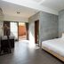 The Silence Manor in Ruisui Township guest room with king bed, concrete walls and sliding door to patio