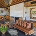 Lion Sands River Lodge in Sabie Park lounge with wood-beamed ceiling, leather seating and fireplace