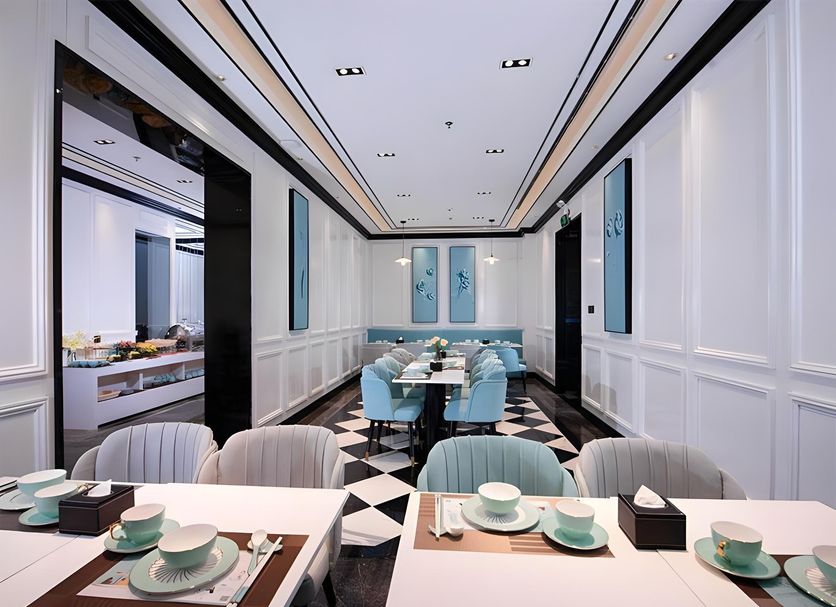 Xana Hotelle Shenzhen Luohu Dongmen dining room with blue chairs and black-and-white tiled floor