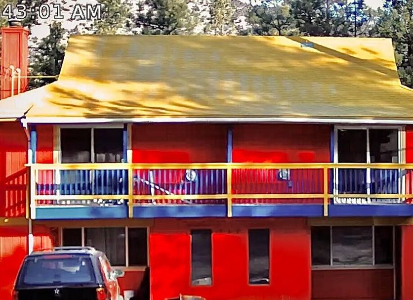 Tao Cabins in Big Bear, bright red cabin with yellow roof and front balcony