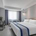Xiamen Junming Hotel in Xiamen: modern guest room with king bed, TV, desk, and large window