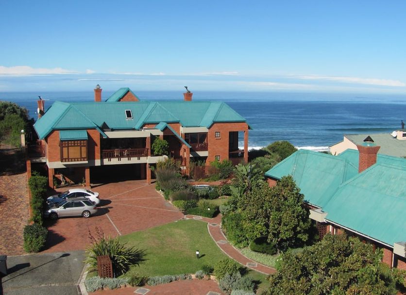 Dolphin Dunes Guesthouse in Wilderness with ocean view and teal-roofed buildings