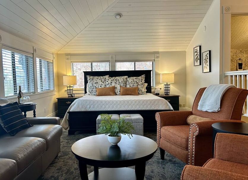 Mccall House Boutique Inn in Ashland guest room with king bed, seating area, and large windows