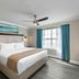 Westgate Branson Lakes Resort in Hollister bedroom with king bed, large window and blue curtains