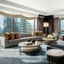 The St. Regis Hong Kong suite with floor-to-ceiling harbor views and modern seating area