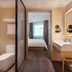 Hanting Hotel Zibo Jinjing Avenue Municipal Government bathroom with toilet, sink and bedroom view