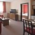 Wellness Apartmanovy dom Familia Smokovec apartment with seating area, TV, and bedroom doorway in Vysoké Tatry