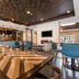 Four Points by Sheraton Elkhart lobby lounge with communal table, bar seating and mounted TV