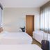 B&B Hotel Pescara guest room with three single beds, nautical wall mural and window curtains