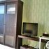 High Point Surabaya room with wardrobe, TV, and patterned green walls in Surabaya