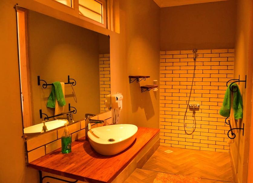 Boulevard Inn Mt Meru, Arusha: modern bathroom with vessel sink, wood vanity, and walk-in shower