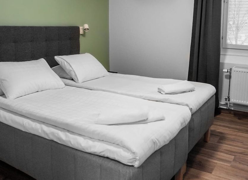 Hotel Aveny Bed & Breakfast in Gävle room with two neatly made single beds by a window