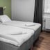 Hotel Aveny Bed & Breakfast in Gävle room with two neatly made single beds by a window