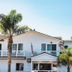 On The Beach Bed And Breakfast in Cayucos with white beachfront exterior and palm trees
