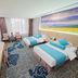 Marriott Hotel Yunfu guest room with two twin beds, seating area, and large landscape wall mural