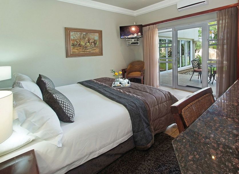 Ushaka Manor Guest House in Umhlanga bedroom with king bed and patio doors to a balcony