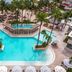 Dreams Aventuras Riviera Maya in Puerto Aventuras with a large palm-lined pool and sun loungers