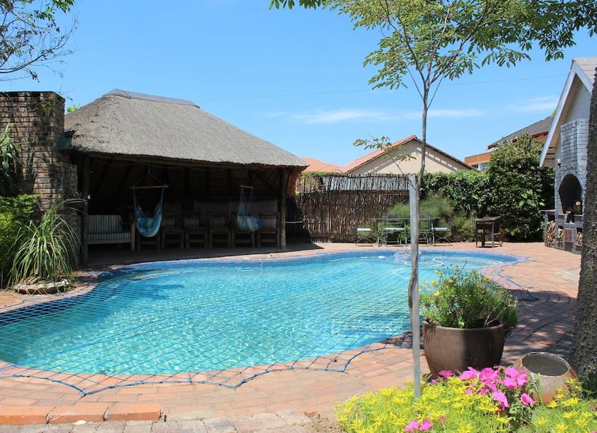 3 Liebeloft Guest House in Johannesburg with a small outdoor pool and thatched patio area