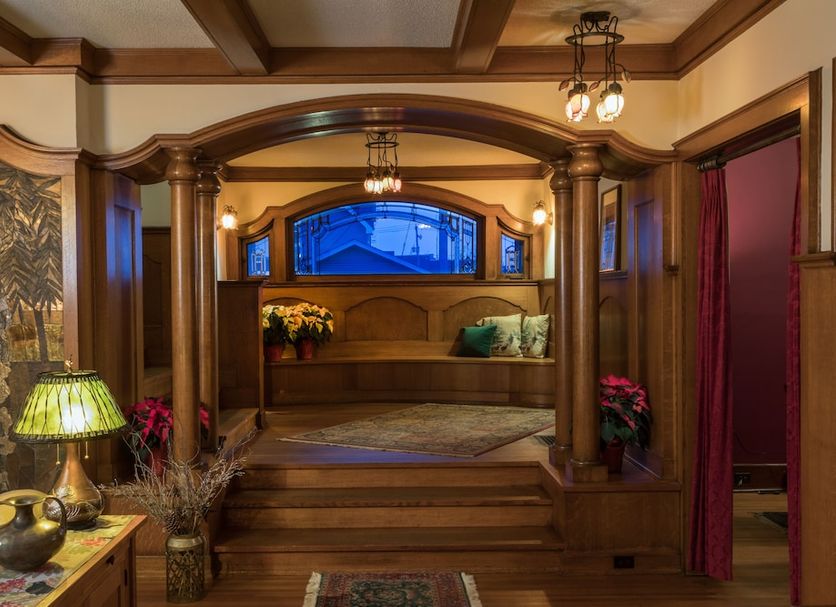 Stewart Inn in Wausau lobby with wood-paneled archway, seating nook, and stained glass window