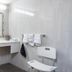 Atherton Park Inn and Suites bathroom with vanity, ornate mirror, grab bars, and shower chair in Redwood City