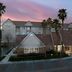 Residence Inn by Marriott San Bernardino exterior at dusk with palm trees and lit entrance
