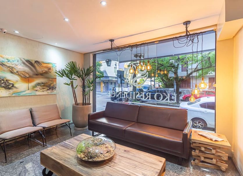 Eko Residence Hotel in Porto Alegre lobby lounge with leather sofa, chairs and large street-facing window