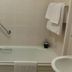 Ard na Breatha in Donegal bathroom with bathtub, glass shower screen, towel rack, and sink
