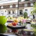 De La Pommeraie, Le Mans: garden terrace with tray of drinks and flowers beside a reflective pool