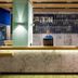 Ibis Budget Givet reception desk with staff member in a modern hotel lobby