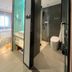 Mingcheng Hotel Beijing bathroom with glass shower, toilet and adjoining bedroom in Beijing