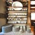 Elia Hotel & Spa, Kolymvari: rustic dining area with shelves of dishes and a wooden table