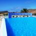 Vila Baleira Porto Santo outdoor pool with ocean and mountain views in Porto Santo