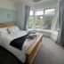 Gwyndra House B&B in St. Austell bedroom with bay window, king bed, and natural light