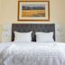 Residencial Lar do Areeiro in Lisbon, simple guest room with double bed, white linens and framed wall art