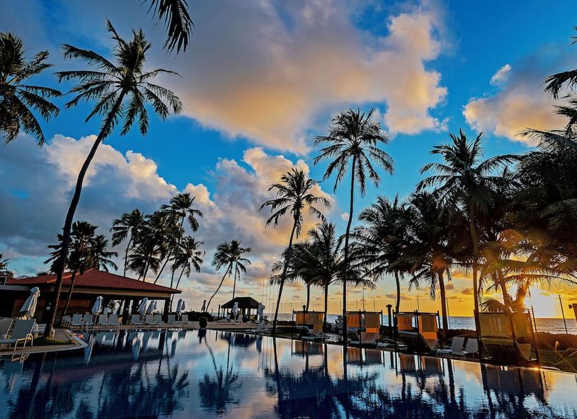 Jatiuca Suites Resort By Slaviero Hoteis in Maceió with palm trees, sunset pool and ocean view