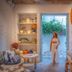 Resort De Paskani in Hua Hin, airy room with woven pendant light and open doorway to a flowered courtyard