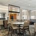 Residence Inn by Marriott Dayton Vandalia breakfast seating area with tables, chairs, and large windows in Dayton