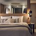 The Royal Senses Resort & Spa Crete, Curio Collection by Hilton guest room with bed and bedside lighting in Panormos