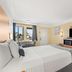 Travelodge by Wyndham San Clemente Beach guest room with bed, TV, mini fridge and balcony view