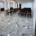Hotel Naivedya in Aurangabad conference hall with rows of chairs and marble flooring